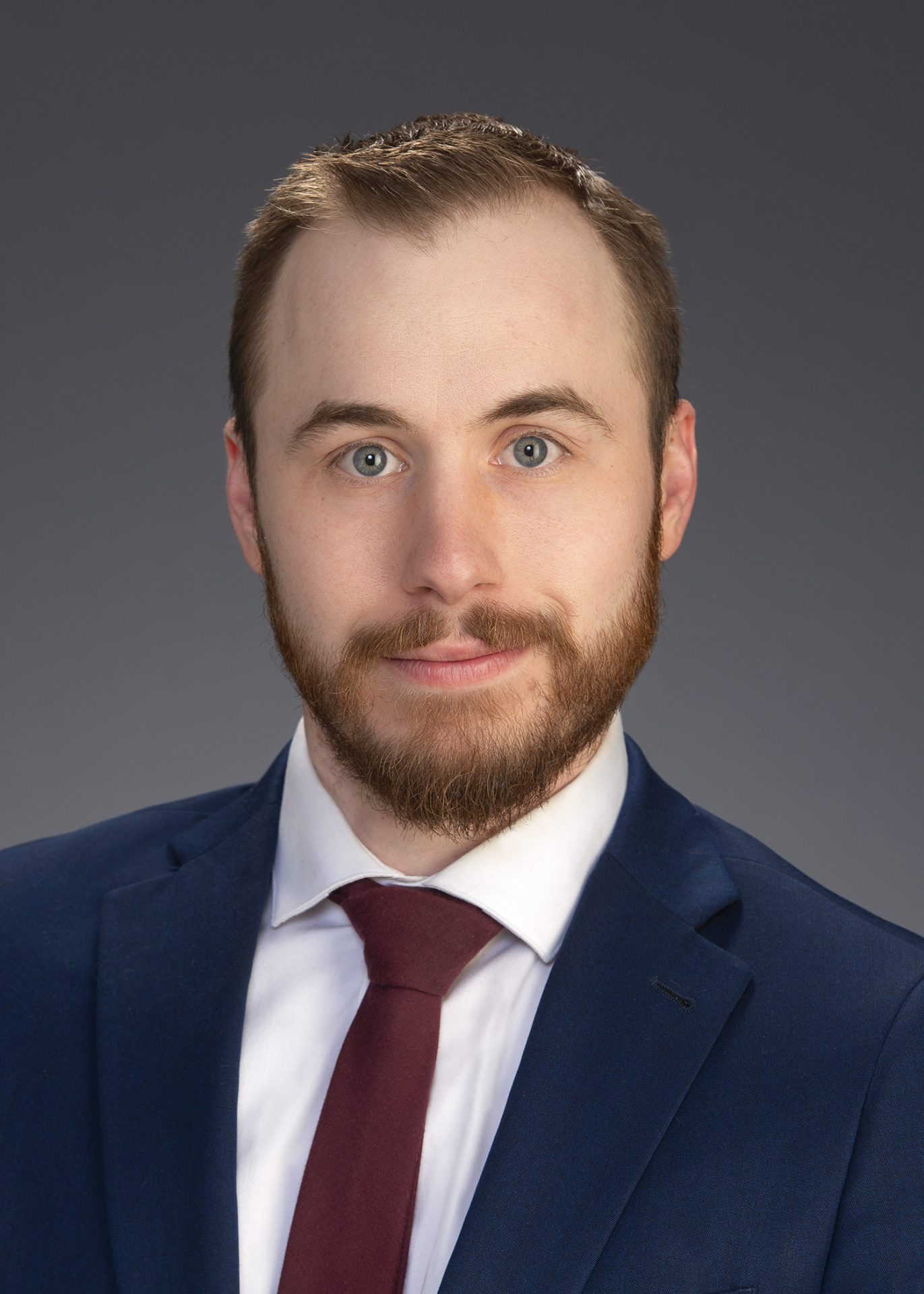 Hartman_Connor_5x7 Man in blue suit with red tie